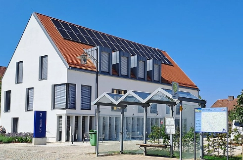 A diverse group of four professionals collaborating at a desk in a modern office.
