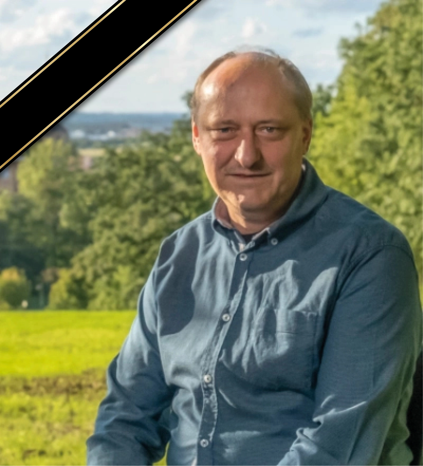 Two young professionals working together at a desk with multiple laptops and a tablet